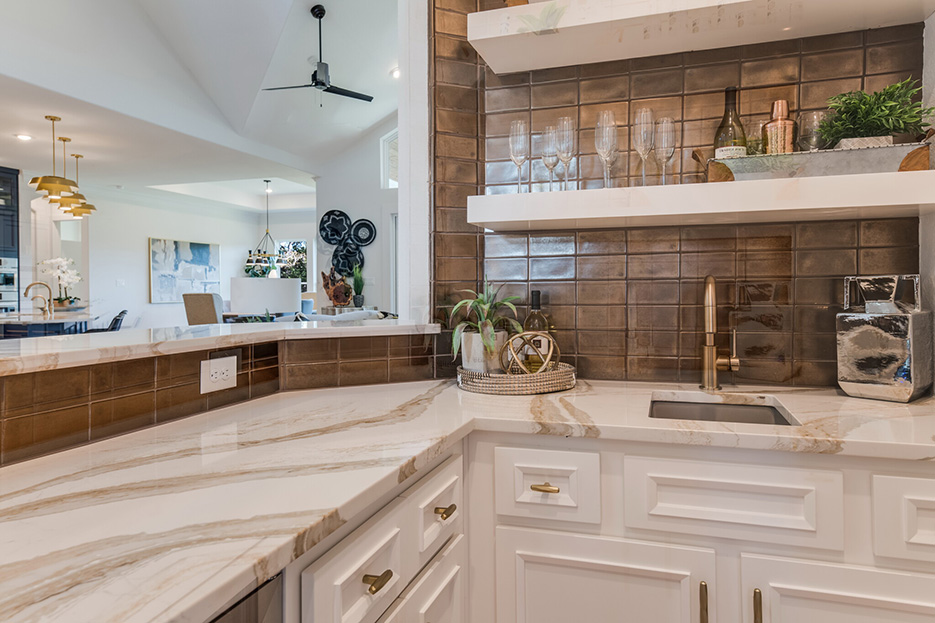 Powdermill development project features Cambria Brittanicca Gold wet bar, coordinated with chocolate-colored ceramic tile splash