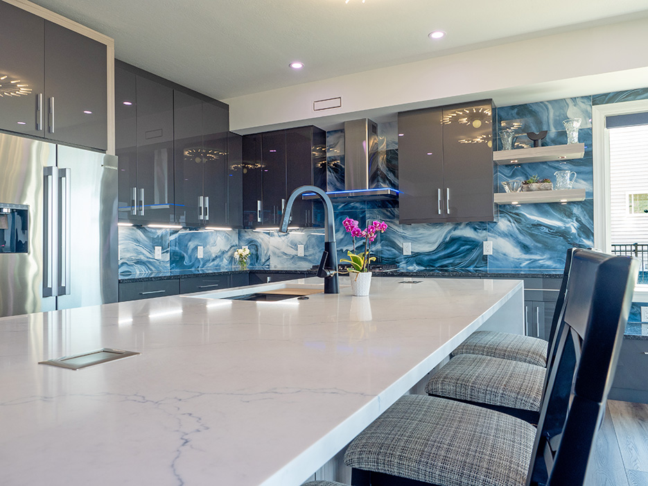 Perimeter Countertops – Blue Pearl Granite.  The mitered Island is Calacatta Miraggio Ciello Quartz from MSI.