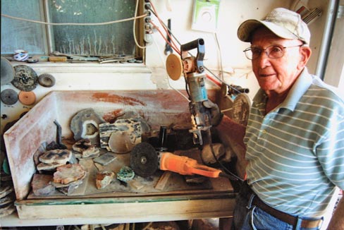 Bryant stands next to his work area where all the pieces get honed and polishe