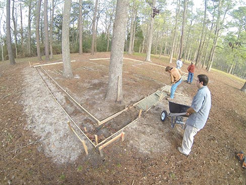 With forms directly above the old foundation, crushed limestone was used as a base before pouring the concrete. 