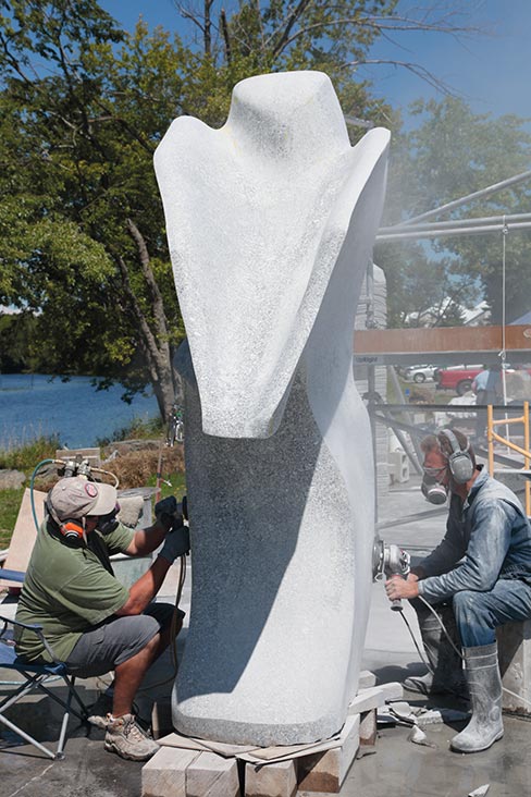 Sculptor Andreas Von Huene (at right) grinds and shapes a curve, while assistant Richard Reichenbach wet polishes the side of a massive granite sculpture at the 2012 Schoodic Symposium in Maine. Power tools like grinders, polishers and saws also play an important role in stone sculpture, and are simply more efficient at removing large amounts of material  than the traditional hammer and chisel.