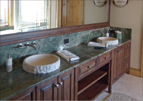 Green rainforest double vanity top with hand-cut marble sinks.