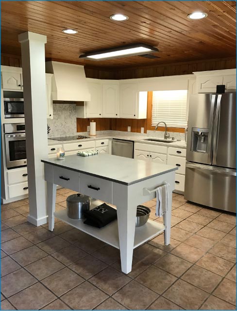 This modern kitchen uses Viatera Rococo quartz countertops and the full height splash to add light and contrast to the rich woods in this upscale project. 