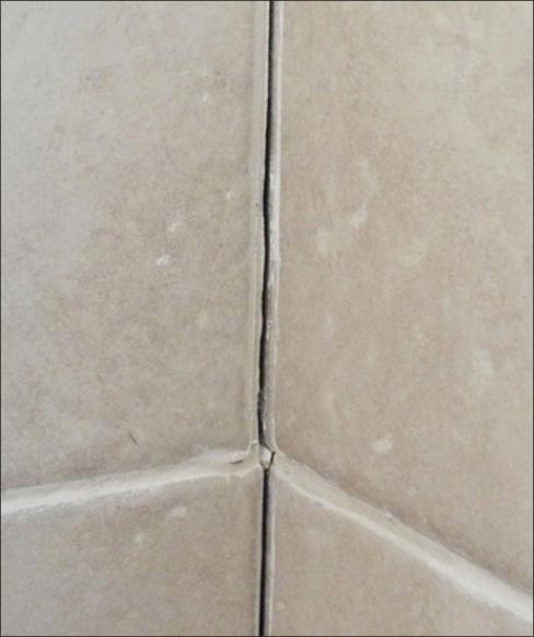 I inspected the shower and found a classic case of grout failure. Corner seams or direction transitions need a “soft joint,” with a more flexible material.