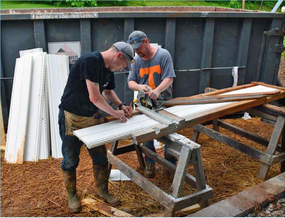 Braxton-Bragg volunteers Matt Maples (left) and Jeff Dykstra trim siding to size at the Habitat for Humanity jobsite.