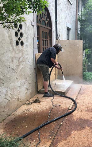 Soda blast cleaning and texturizing a dimensional marble stoop. The client requested a high grip surface profile  without grinding marks left behind, so a blasting professional with the specialized equipment was contracted to handle this small but important project. Note the plywood panels laid down to protect adjacent surfaces.