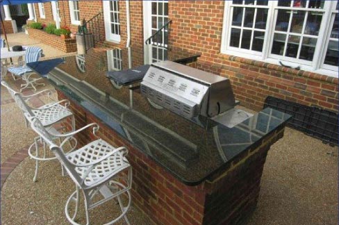 This full slab, outdoor kitchen island uses a durable granite.