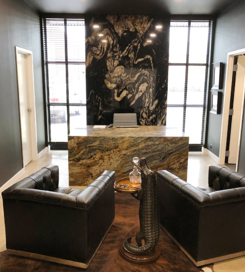 Sample as well as workspace: Dustin Hughes’ Stone Studio office features a Golden Crystal waterfall desk and a  Titanium granite wall feature.