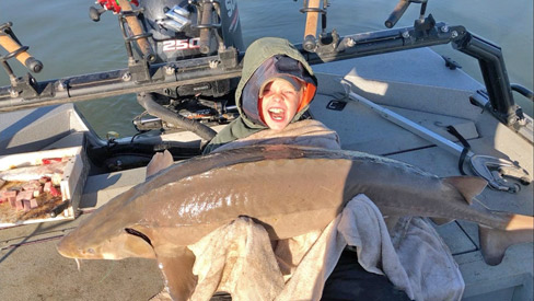 Coye Price with 80-pound sturgeon