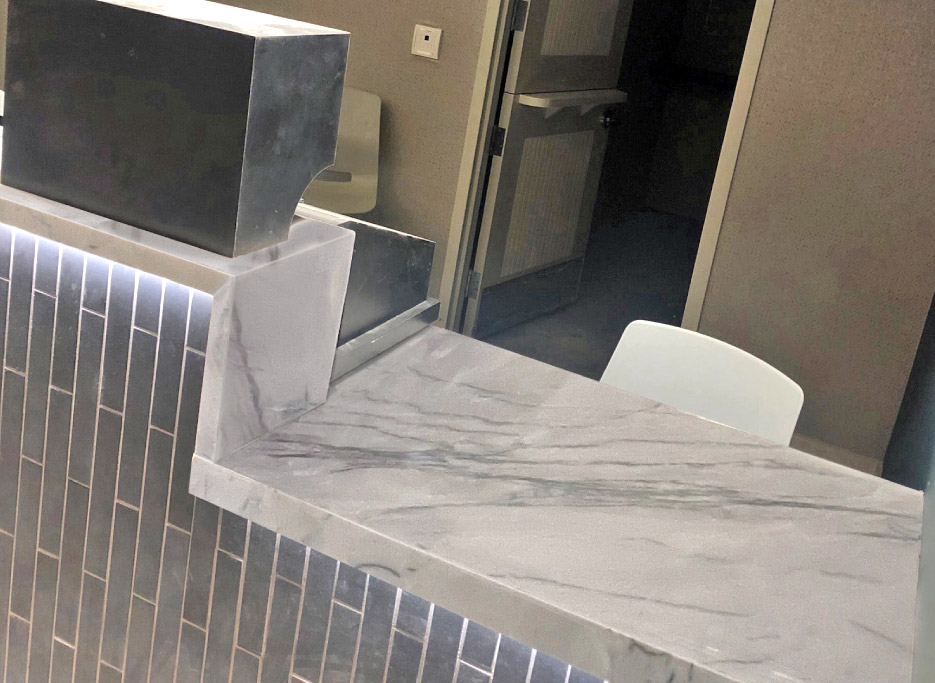 Installation in progress on the Mutual betting counter (above, and below), which also used mitered Calcutta quartzite for the top and front counter edge. In all, an estimated 1,000 square feet of hard-wearing quartzite stone were used on this phase of the Churchill Downs project.