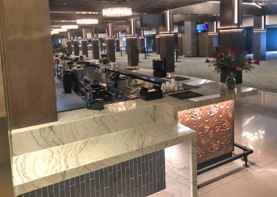 the Homestretch bar wraps around to a complex, mitered ADA-compliant countertop. “Precise templating and cutting was an essential part of a smooth install on this job,” said Dani Silverthorn.