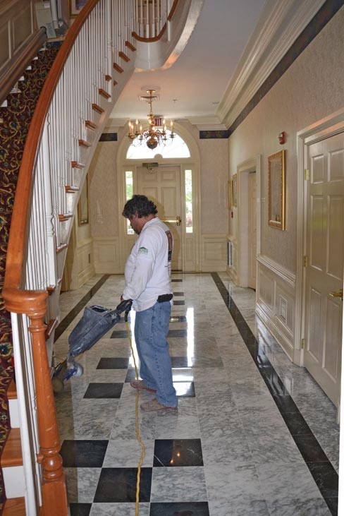 Final polish of foyer brought back the deep glow of the green marble and darker inlay.