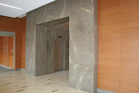 2 cm Cafe Bruno from Walker Zanger was used for elevator cladding. The marble tile in the lobby is 18˝x18˝ Olive Marone from Akdo. The project so far has entailed installing about 3,500 square feet of stone cladding, about 2,500 square feet of marble tile installation, and about 3,000 square feet of granite sidewalk installation. 