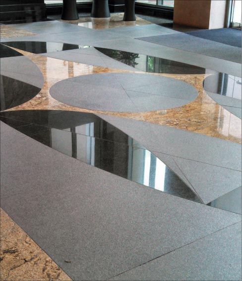 Combination of flamed granite with polished granite and marble for contrasting effect.