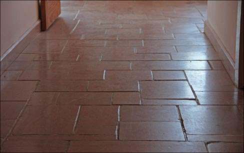 An example of moderate to severe lippaage:  You can easily see how the uneven surface would be diffucult to maintain, hard to wax or even dust mop. 