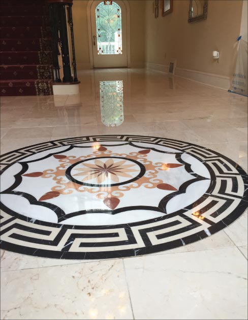 On this elaborate residential floor, eight tiles were removed and replaced where the reflection of the door is in the floor. Moderate lippage was removed and honed with a hand tool, then the entire floor was polished using the new Majestic XXX Shine Powder.