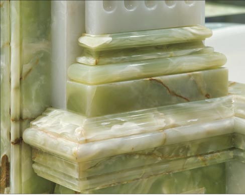 Column and trim detail from an opulent master bath lavishly decorated with Green and White onyx.