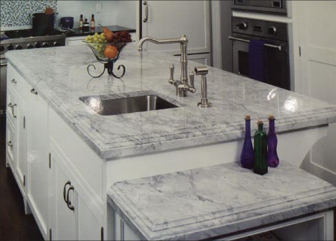 Laminated Newport White Quartzite island with matching wine cooler table top for a custom residence in New York.