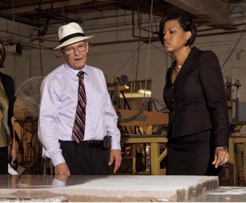 From Left: Hilgartner President Tom Doyle and Baltimore Mayor Stephanie Rawlings-Blake discuss a slab of Tennessee Cedar being polished on Hilgartner’s vintage 1953 Hysaman polisher.