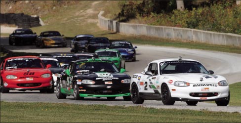 Berry (number 29, black and green) battles  to overtake lead car at Road America race, Elkhart Lake, Wisconsin.