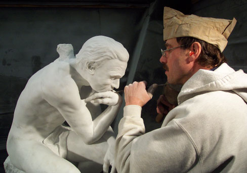 Wilson working on a replica of Rodin’s Thinker, a private sculpture commission, carved from Vermont Danby Imperial marble. Wilson is wearing a traditional “marble worker” paper hat.