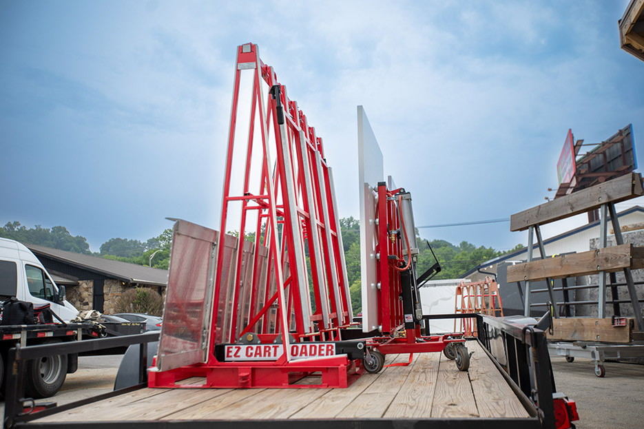 Starting at the shop: loading a large island top from EZ Installation Cart to a transport cart.