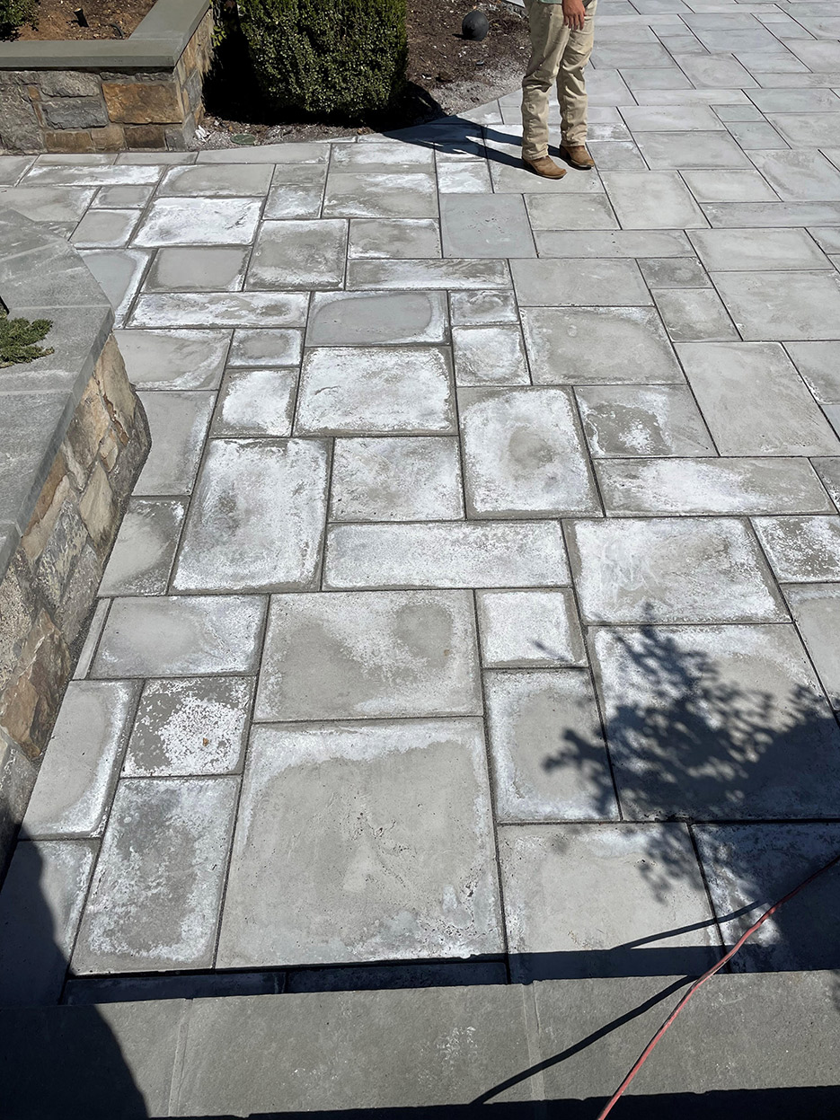 The result of a contractor's liquid mixture on the pavers in an unsuccessful attempt to make them look like marble