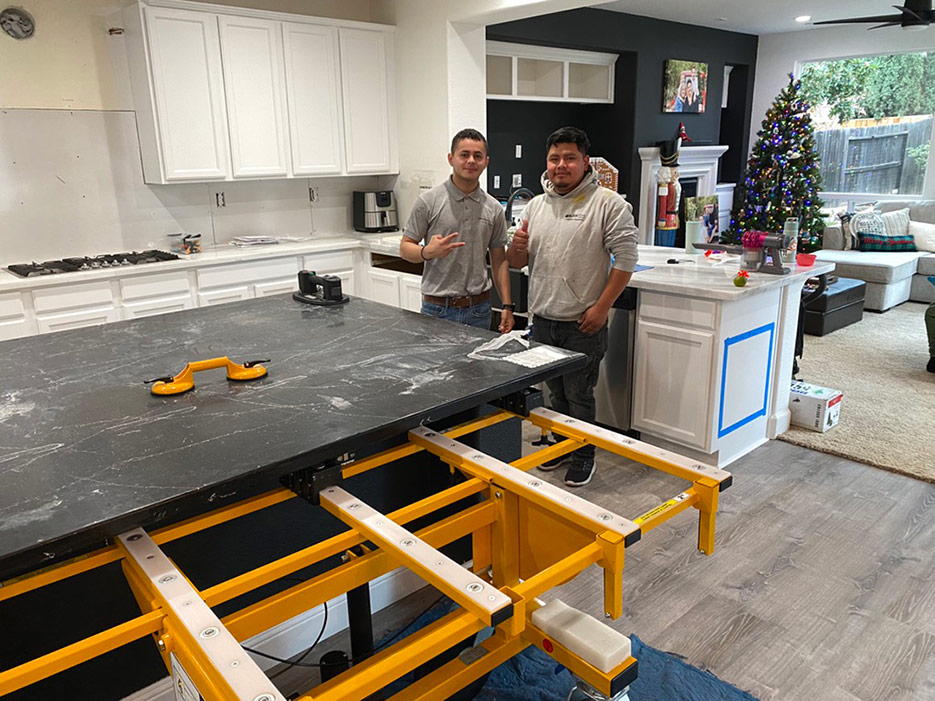 A Block Tops installer team from the Anaheim office moves a full size island into place with their No-Lift Cart.