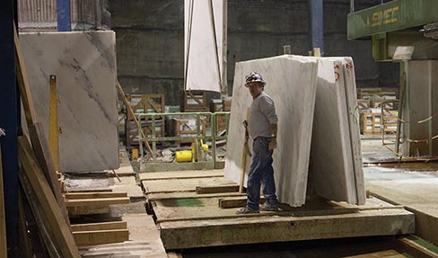 A fully-equipped underground shop processes marble from block to polished slabs and tiles.