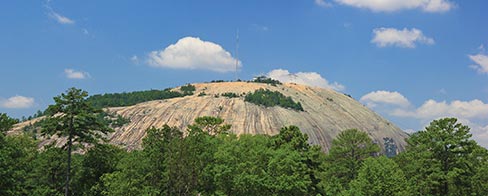 The Stone Mountain carving is just visible at the lower right, above the trees in the foreground.