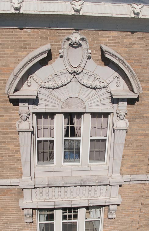 Full view of an upper floor balcony restoration, and a close-up of a terra cotta pilaster–preserving a jewel of architectural ornamentation.