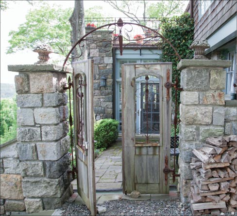 This solidly-built gate with stone pillars is located in Tuxedo Park, NY. Mike chose to leave in the drill marks, for a rugged texture. “Drill marks are like red wine; you have to acquire a taste,” he explained.  “The guys that did the railings were the same guys from Orange County Choppers before they began building custom bikes. They were iron workers before they got into choppers.” According to Mike, the stone pillars he builds are always made of solid stone and never filled with block or concrete.