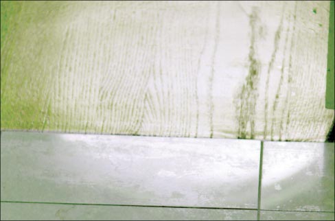 Above: An example where the existing conditions can create some complexity in the job: here, marble flooring butts directly up to wood paneling.