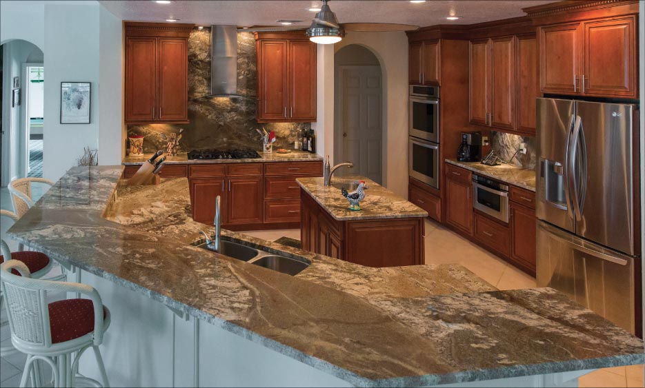 Full kitchen remodel featuring beveled 3cm Netuno Bordeaux granite countertops and full height backsplash makes the most of movement in the slabs. Akemi products were used to secure splashes as well as blend seams.