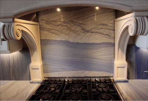  “The client assisted with the layout and wanted the material veining to run vertical, with the exception of the backsplash behind the range. The client selected Blue Macaubas Quartzite from an out-of-state supplier, and we shipped it in for this project.” 