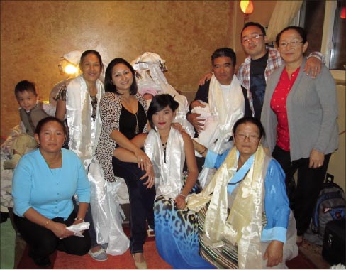 Ngima Sherpa with his family for his twin daughters’ “Welcome to the Earth” party in September, 2012. Sherpa is in the back row, seated with baby in hand, with her twin sister in the bassinet behind him. In front kneeling, Ngima’s aunt Nuwang – his eldest daughter Tsering Sherpa in center, and his mother Ang Chokpa. Back row – Ugyen Norzang, Ngima’s wife Sushma Thapa Sherpa, cousin Jazmine Ing, twin daughters Aurora and Oriana Sherpa, Ngima Sherpa, Drona Ing and Ngima’s aunt Pasang Sherpa.