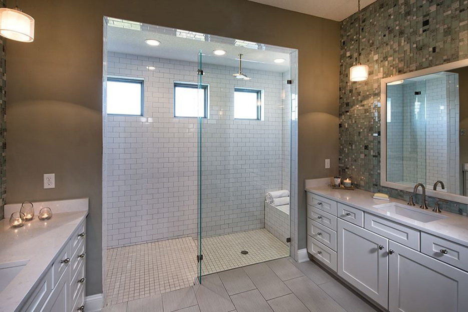 This spacious main bath features double vanities and custom walk-in / roll-in shower.