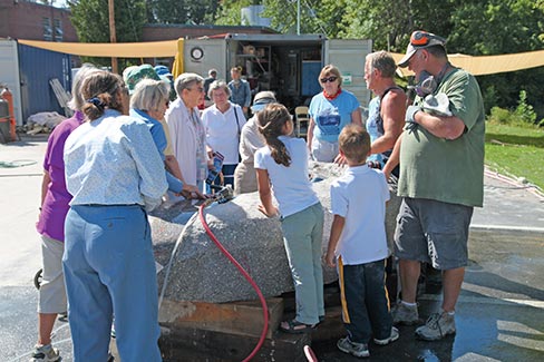 A captivated audience listens as Ton Kalle explains the many steps involved in large-scale granite sculpting