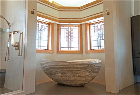 Each of the several baths in this large, Frank Lloyd Wright-inspired home has a different blend of materials and design, from classic porcelain tile and marble to the clean lines of ultra-modern silestone. Keith’s install team worked with the client’s material choices, often edging the tile onsite.