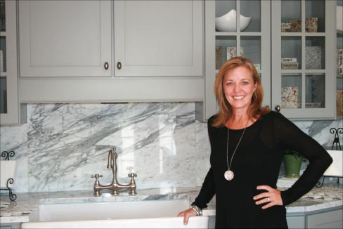 Laura da Ponte in the Stone Creek Surfaces showroom. Stone Creek keeps over 100 slabs on site for customers to browse color and stone choice, including exotics like the Honey Onyx