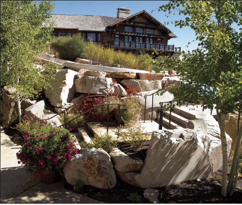 Mountain Valley quartzitic sandstone boulders help create a natural setting in this terraced hardscape. 