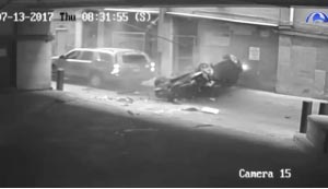 Surveillance video from an Austin, Texas parking garage shows a car dropping out of the sky and crashing in an alley.