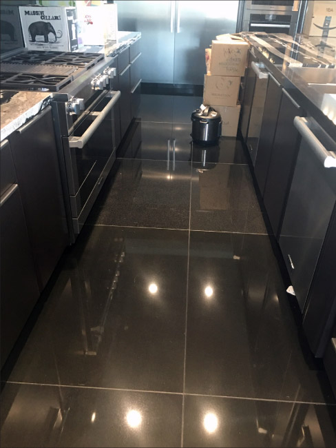 Exhibit A: High-end installation, Black Absolute large format floor tiles. How many color variations can you spot in this one photo? Unfortunately, there are no universally accepted and enforced Industry standards to define what is premium grade Black Absolute, and what is not. 