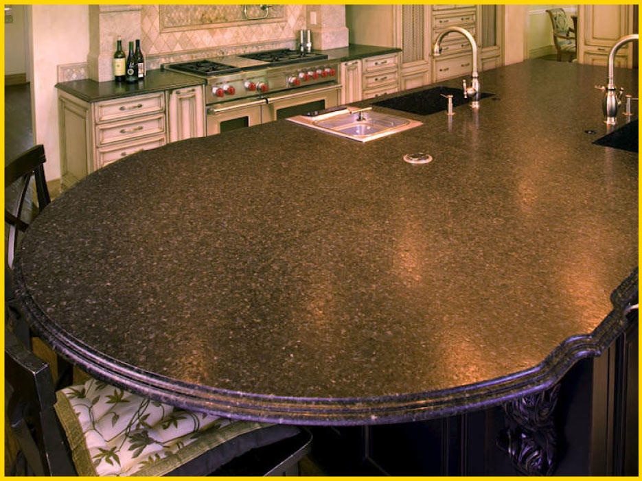 The understated texture of this elaborate Ubatuba island blends with the antiqued cabinets in this large kitchen, instead of overpowering. This understated elegance is part of the appeal of Percoco’s finishes, like the built-in Verde Bellagio granite farmhouse sink 