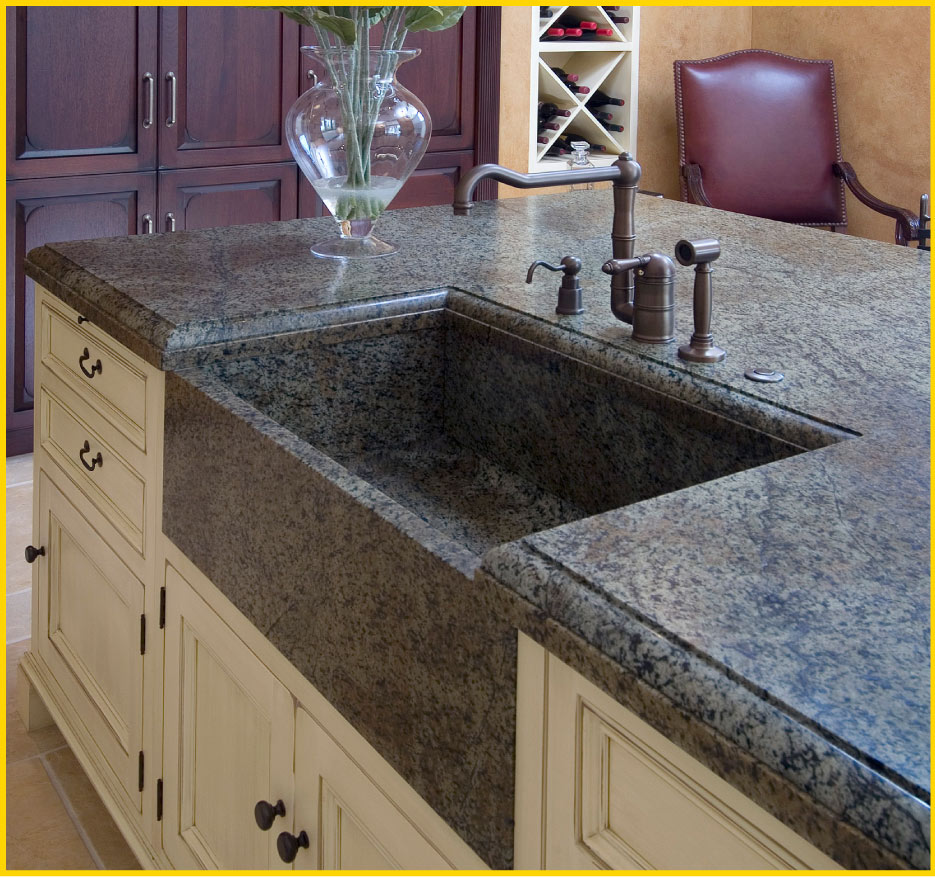 The understated texture of this elaborate Ubatuba island blends with the antiqued cabinets in this large kitchen, instead of overpowering. This understated elegance is part of the appeal of Percoco’s finishes, like the built-in Verde Bellagio granite farmhouse sink 