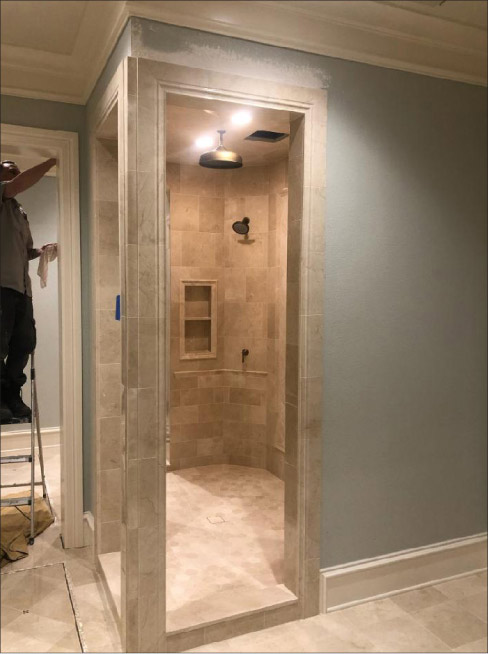 A custom Crema Marfil shower was installed in the same bathroom. All walls and columns had been flattened per industry standards before tile was installed. All resin-backed stone was primed with a single component primer suitable for wet areas and installed with minimum 95 percent mortar coverage per industry standards. Photo courtesy Stoneman Construction LLC, Portland, Oregon.