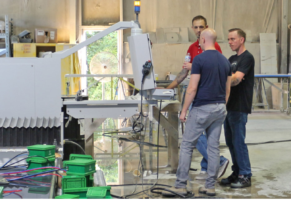 Jerry Herring and Josh Hart set up CNC tooling at Stone Creek Surfaces