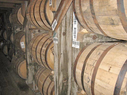 Rows upon rows of maturing barrels fill the warehouses