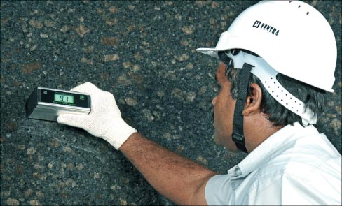 Tight quality control is a must in today’s competitive market, and Madhav Marbles & Granites Limited takes it very seriously, as seen here during a gloss meter spot check of their Coffee Brown granite. 