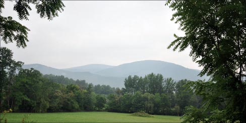 The Blue Ridge Mountains grace the view from the porch of this secluded retreat. 